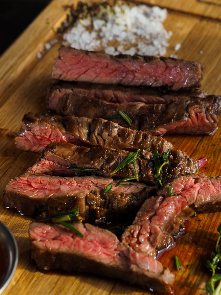 Sliced grilled rump steak on a board